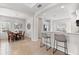 Open-concept dining area with wood table, chandelier, and view to the kitchen at 4954 Newport News Cir, Lakewood Ranch, FL 34211