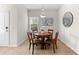 Cozy dining room featuring a round wood table, chandelier, and a bright window at 4954 Newport News Cir, Lakewood Ranch, FL 34211