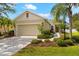Front exterior showcasing a one-story home with a well-manicured lawn and attached garage at 4954 Newport News Cir, Lakewood Ranch, FL 34211