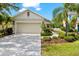 Exterior view of the front yard showcasing a well-maintained lawn and attached garage at 4954 Newport News Cir, Lakewood Ranch, FL 34211