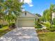 Charming home with a well-manicured lawn, mature trees, and a spacious driveway at 4954 Newport News Cir, Lakewood Ranch, FL 34211