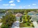 Inviting single-Gathering home featuring a well-maintained lawn, mature trees, and a paved driveway leading to the garage at 4954 Newport News Cir, Lakewood Ranch, FL 34211