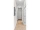 Bright hallway featuring tile floors and neutral walls leading to various rooms in the house at 4954 Newport News Cir, Lakewood Ranch, FL 34211