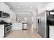 Open-concept kitchen with stainless steel appliances, white cabinets, and an open layout at 4954 Newport News Cir, Lakewood Ranch, FL 34211