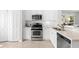 Well-lit kitchen with stainless steel appliances, white cabinets, and a view of the backyard at 4954 Newport News Cir, Lakewood Ranch, FL 34211