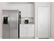 Efficient kitchen area includes stainless steel refrigerator and Keurig machine and white cabinets for ample storage at 4954 Newport News Cir, Lakewood Ranch, FL 34211