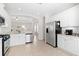 Bright kitchen features stainless steel appliances, white cabinets, and an open layout leading to the living area at 4954 Newport News Cir, Lakewood Ranch, FL 34211