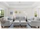 Bright living room with neutral sofas, accent pillows, and ceiling fan at 4954 Newport News Cir, Lakewood Ranch, FL 34211