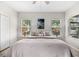 Inviting bedroom showcasing neutral tones, natural light from two windows, and a ceiling fan at 4954 Newport News Cir, Lakewood Ranch, FL 34211