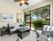 Relaxing screened patio featuring stylish wicker furniture and ceiling fan at 4954 Newport News Cir, Lakewood Ranch, FL 34211