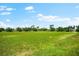 An image shows a large grassy soccer field with soccer goals and trees in the background at 4954 Newport News Cir, Lakewood Ranch, FL 34211