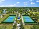 A park view shows two tennis courts and landscaping with a pavilion and walking paths at 4954 Newport News Cir, Lakewood Ranch, FL 34211
