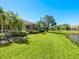 Lush backyard featuring mature trees and landscaping, with views of screened in porch at 5087 Timber Chase Way, Sarasota, FL 34238