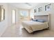 Bright bedroom with stylish windows and light-colored tile floors at 5087 Timber Chase Way, Sarasota, FL 34238