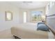 Bright bedroom with stylish windows and light-colored tile floors at 5087 Timber Chase Way, Sarasota, FL 34238