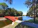 Community park area featuring a decorative red bridge and serene water views at 5087 Timber Chase Way, Sarasota, FL 34238
