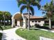 Welcoming clubhouse with a distinctive tiled roof, arched entrance, and well-maintained landscaping at 5087 Timber Chase Way, Sarasota, FL 34238