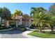 Community clubhouse entrance highlighted by arched entryway and meticulous landscaping at 5087 Timber Chase Way, Sarasota, FL 34238