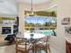 Breakfast nook with pool views, and a cozy living room with a fireplace at 5087 Timber Chase Way, Sarasota, FL 34238