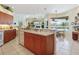Island kitchen with double sinks and views into the living room at 5087 Timber Chase Way, Sarasota, FL 34238