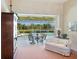 Comfortable seating area on the lanai offers a tranquil view of the community pond and pool at 5087 Timber Chase Way, Sarasota, FL 34238