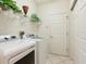 Well-organized laundry room with modern washer and dryer, shelving, and ample storage space at 5087 Timber Chase Way, Sarasota, FL 34238