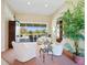 Inviting living room with large windows and comfortable seating next to decorative greenery at 5087 Timber Chase Way, Sarasota, FL 34238