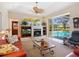 Comfortable living room featuring a fireplace and access to an outdoor pool area at 5087 Timber Chase Way, Sarasota, FL 34238
