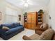 Cozy living room with comfortable seating, a built-in wooden cabinet, and plenty of natural light at 5087 Timber Chase Way, Sarasota, FL 34238