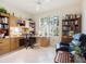 Bright office space with built-in bookshelves, desk, and large window at 5087 Timber Chase Way, Sarasota, FL 34238