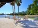 Outdoor patio seating overlooking the serene lake with fountain at 5087 Timber Chase Way, Sarasota, FL 34238