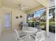 Cozy screened patio with outdoor dining area, perfect for enjoying the serene backyard view at 5087 Timber Chase Way, Sarasota, FL 34238