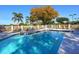 Community pool and sundeck area with lounge chairs and views of mature trees at 5087 Timber Chase Way, Sarasota, FL 34238