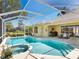 Stunning screened-in pool and hot tub, adjacent to an outdoor kitchen and dining area at 5087 Timber Chase Way, Sarasota, FL 34238