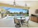 Screened lanai showcasing a pool with a tranquil lake view and outdoor bar at 5087 Timber Chase Way, Sarasota, FL 34238