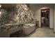 Luxurious bathroom with a marble accent wall, soaking tub, and custom vanity at 550 Golden Gate Point # 304, Sarasota, FL 34236