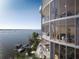 Modern condominium featuring floor-to-ceiling windows with a balcony and breathtaking waterfront views at 550 Golden Gate Point # 304, Sarasota, FL 34236