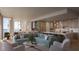 Open-concept living room with modern furnishings, a gourmet kitchen, and panoramic water views at 550 Golden Gate Point # 304, Sarasota, FL 34236