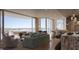 Stylish living room with contemporary design, a gourmet kitchen, and breathtaking water views at 550 Golden Gate Point # 304, Sarasota, FL 34236
