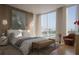 Serene main bedroom with floor-to-ceiling windows and a view of the marina and city skyline at 550 Golden Gate Point # 304, Sarasota, FL 34236