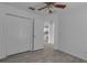 Neutral bedroom with wood-look tile flooring and bi-fold closet at 5511 71St E St, Palmetto, FL 34221