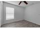 Bright bedroom with wood-look tile flooring, neutral paint, and a ceiling fan at 5511 71St E St, Palmetto, FL 34221