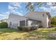 Exterior view of home with screened-in porch and well-maintained landscaping at 5753 Summer Side Ln # 8A, Sarasota, FL 34231