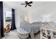 Bright bedroom with monochrome decor featuring striped bedding, window, and a plush ottoman at 5806 43Rd E Ct, Bradenton, FL 34203