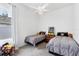 Cozy bedroom with two twin beds, a window, ceiling fan, and whimsical decor, including fun pillows at 5806 43Rd E Ct, Bradenton, FL 34203