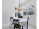 Cozy dining area with a chandelier, large windows offering natural light, and seating for four at 5806 43Rd E Ct, Bradenton, FL 34203