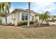 Well-manicured lawn and landscaping accent the beautiful home exterior at 5806 43Rd E Ct, Bradenton, FL 34203