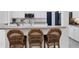 Kitchen breakfast bar with seating and stainless steel appliances and white cabinets at 5806 43Rd E Ct, Bradenton, FL 34203