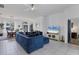 Bright living room and dining area featuring tile floors, neutral walls, and a comfortable blue couch at 5806 43Rd E Ct, Bradenton, FL 34203