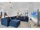 Bright living room boasts plush blue sectional sofa, tile floors, and a view of dining area and front entry at 5806 43Rd E Ct, Bradenton, FL 34203